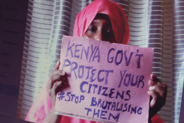 Woman holding a poster saying "Kenya government protect your citizens #Stop brutalising them"